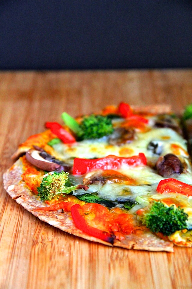 Pumpkin Hummus Tortilla Pizza -- A non-traditional pizza that replaces tomato sauce with pumpkin hummus and trades in pizza dough for a simple tortilla that gets crispy on the edges and remains soft and gooey towards the centre.