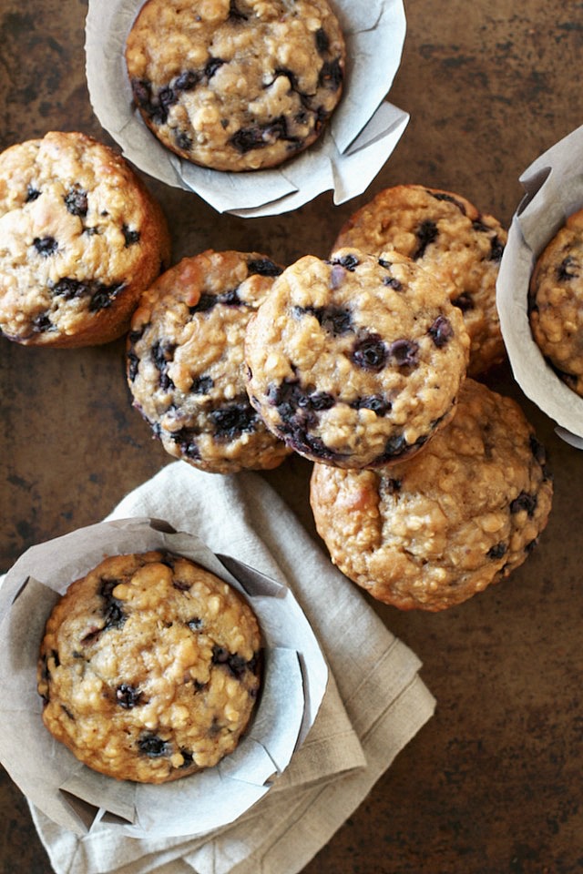 You won't find any butter or oil in these ridiculously soft and tender Blueberry Oat Greek Yogurt Muffins! What you will find is plenty of naturally sweetened, blueberry goodness in each bite! | runningwithspoons.com #healthy #muffins #breakfast #snack