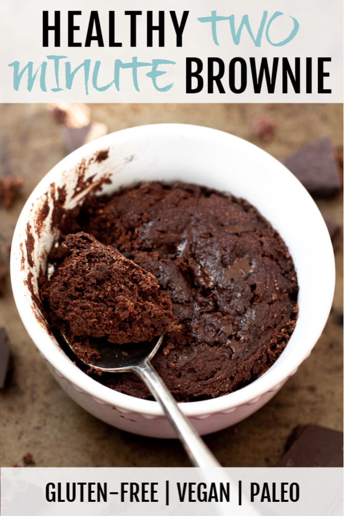 A healthy two minute brownie in a small ramekin with a spoonful laying on top.