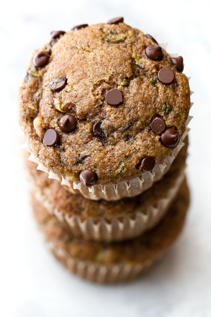 Flourless chocolate chip zucchini banana muffins that are so tender and flavourful, you'd never know they were made without flour, oil, or refined sugar. Gluten free and made with wholesome ingredients, they make a healthy and delicious breakfast or snack | runningwithspoons.com