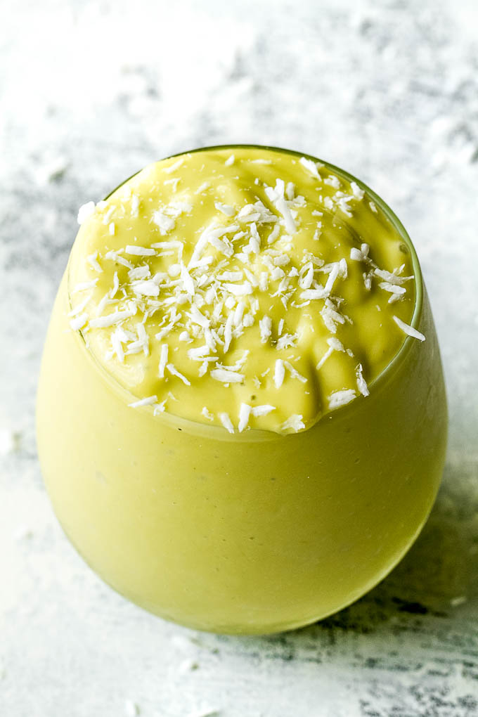 This super creamy Mango Avocado Smoothie is packed with protein, healthy fats, vitamins and antioxidants. Gluten-free and easily made vegan, it makes a healthy and delicious breakfast or snack | runningwithspoons.com