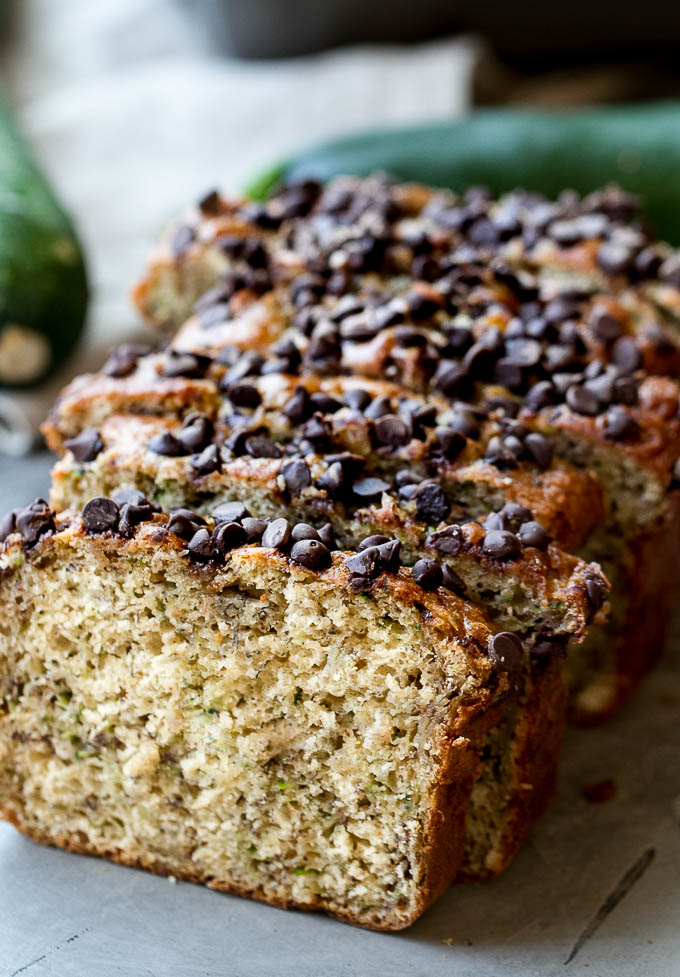 One Bowl Zucchini Banana Bread - made without butter or oil, but so tender and flavourful that you’d never be able to tell it's healthy! Greek yogurt, bananas, and shredded zucchini keep it extra moist, while a sprinkle of chocolate chips make it feel extra decadent | runningwithspoons.com