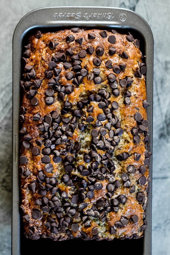 One Bowl Zucchini Banana Bread - made without butter or oil, but so tender and flavourful that you’d never be able to tell it's healthy! Greek yogurt, bananas, and shredded zucchini keep it extra moist, while a sprinkle of chocolate chips make it feel extra decadent | runningwithspoons.com