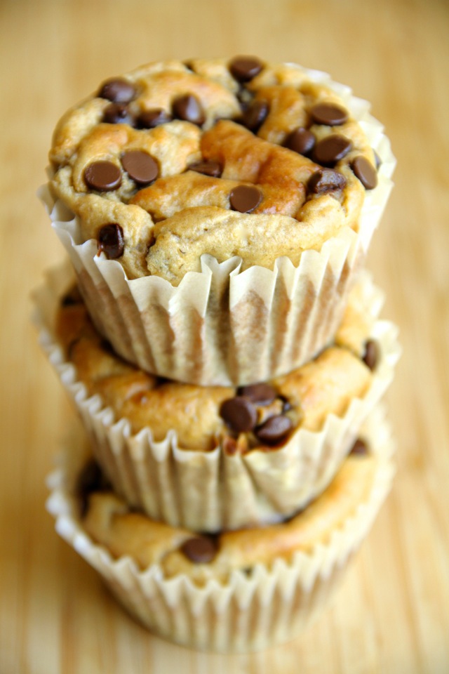 A stack of banana oat greek yogurt muffins with chocolate chips.