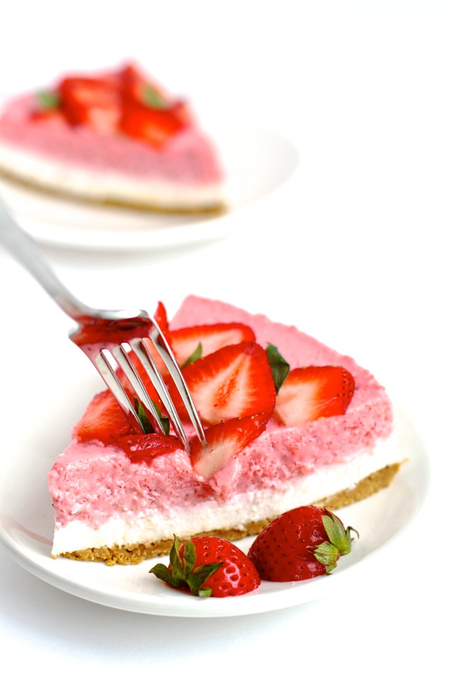 High in protein, low in fat, low in sugar, and roughly 150 calories per slice -- this No Bake Strawberry Cheesecake makes a perfect cool and creamy summer treat! || runningwithspoons.com