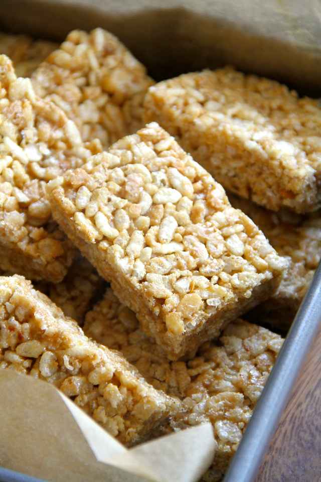 Protein Rice Krispie Treats -- a grown-up twist on a classic childhood favourite! Made without butter or marshmallows, these healthy bars are vegan, gluten-free, refined sugar-free, and make a great balanced snack! || runningwithspoons.com