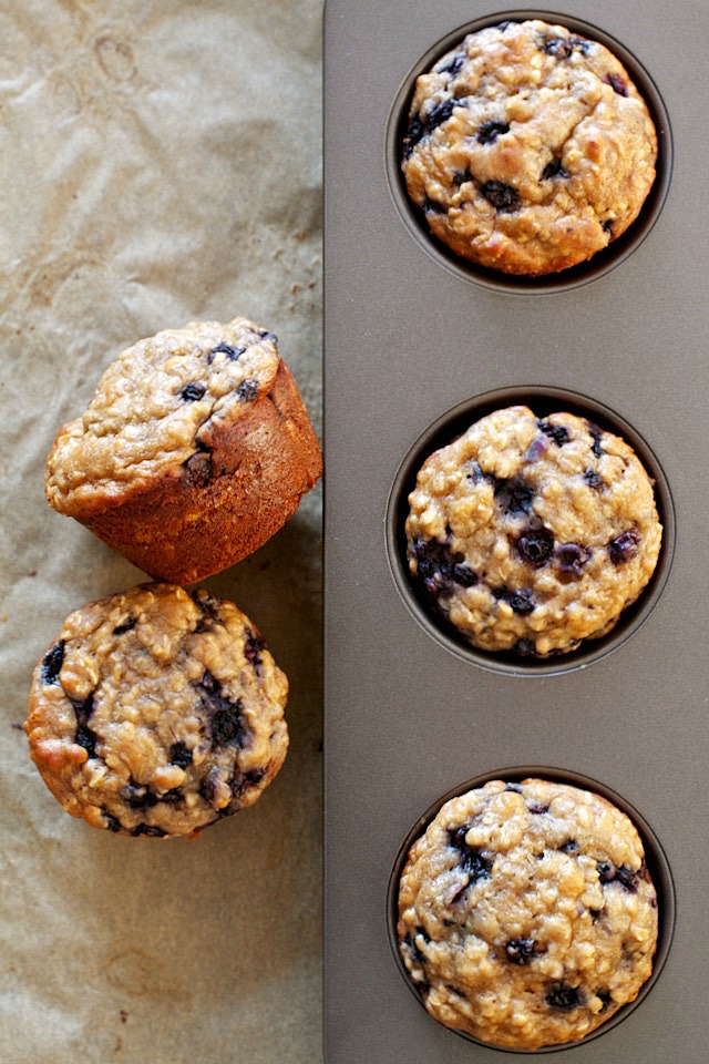 You won't find any butter or oil in these ridiculously soft and tender Blueberry Oat Greek Yogurt Muffins! What you will find is plenty of naturally sweetened, blueberry goodness in each bite! | runningwithspoons.com #healthy #muffins #breakfast #snack