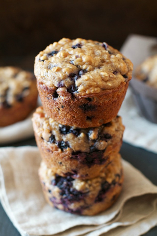 You won't find any butter or oil in these ridiculously soft and tender Blueberry Oat Greek Yogurt Muffins! What you will find is plenty of naturally sweetened, blueberry goodness in each bite! | runningwithspoons.com #healthy #muffins #breakfast #snack