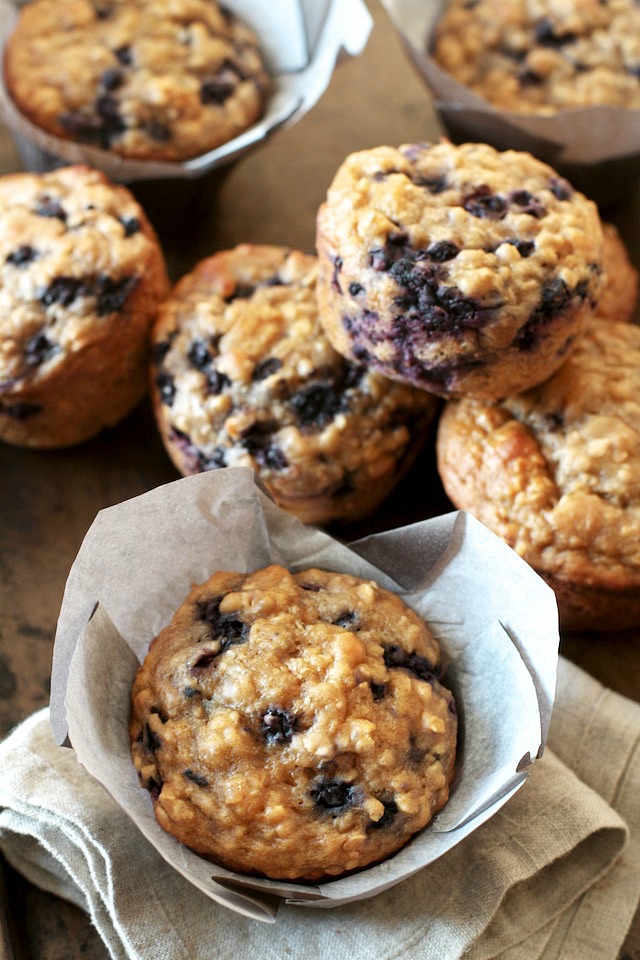 You won't find any butter or oil in these ridiculously soft and tender Blueberry Oat Greek Yogurt Muffins! What you will find is plenty of naturally sweetened, blueberry goodness in each bite! | runningwithspoons.com #healthy #muffins #breakfast #snack