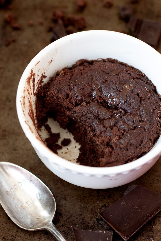 A healthy two minute brownie with a bit scooped out of the ramekin.