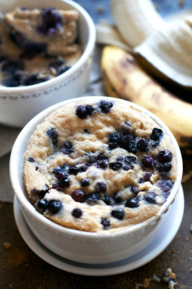 Satisfy your banana bread cravings in less than 5 minutes with this healthy Blueberry Banana Bread Mug Cake! It's made without flour, butter, or oil, but so light and fluffy that you'd never be able to tell! | runningwithspoons.com #glutenfree #grainfree #paleo #recipe