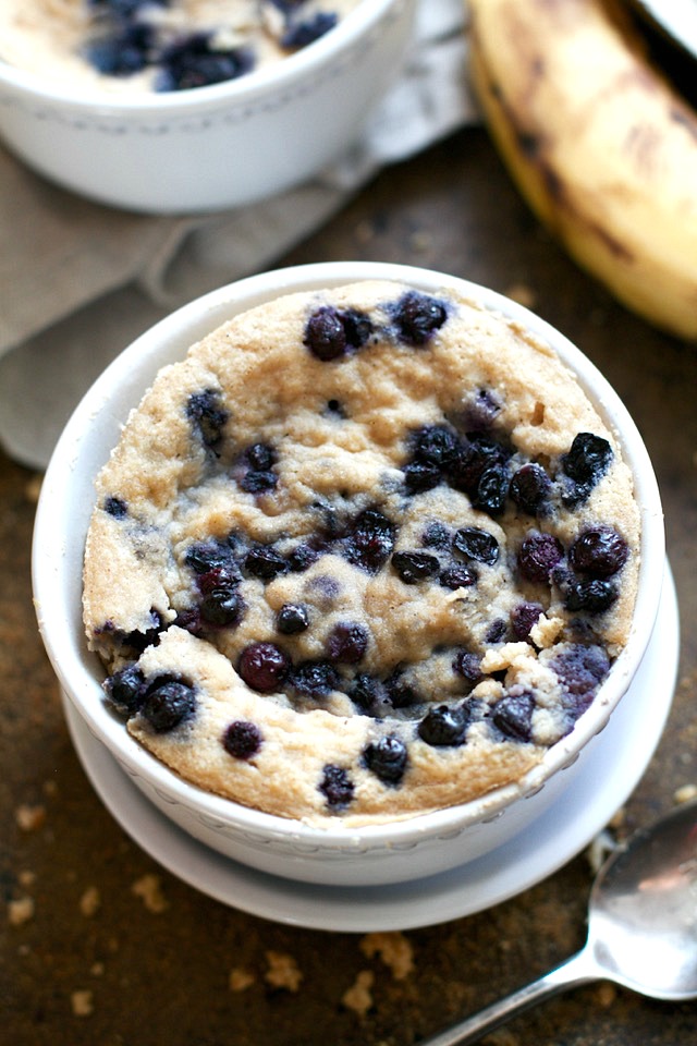 Satisfy your banana bread cravings in less than 5 minutes with this healthy Blueberry Banana Bread Mug Cake! It's made without flour, butter, or oil, but so light and fluffy that you'd never be able to tell! | runningwithspoons.com #glutenfree #grainfree #paleo #recipe