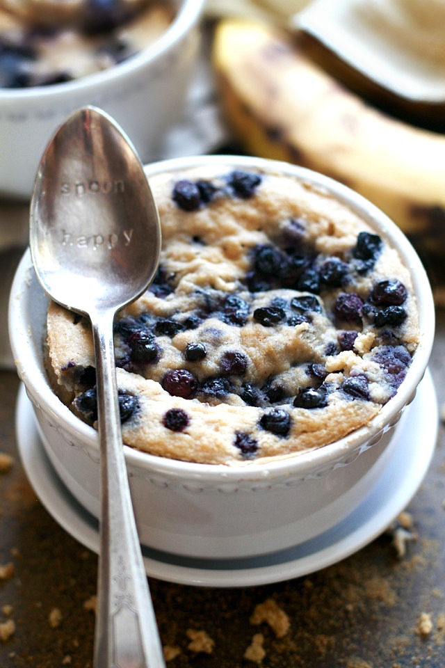 Satisfy your banana bread cravings in less than 5 minutes with this healthy Blueberry Banana Bread Mug Cake! It's made without flour, butter, or oil, but so light and fluffy that you'd never be able to tell! | runningwithspoons.com #glutenfree #grainfree #paleo #recipe