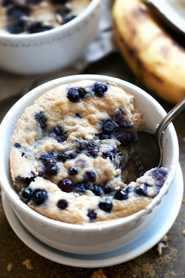 Satisfy your banana bread cravings in less than 5 minutes with this healthy Blueberry Banana Bread Mug Cake! It's made without flour, butter, or oil, but so light and fluffy that you'd never be able to tell! | runningwithspoons.com #glutenfree #grainfree #paleo #recipe