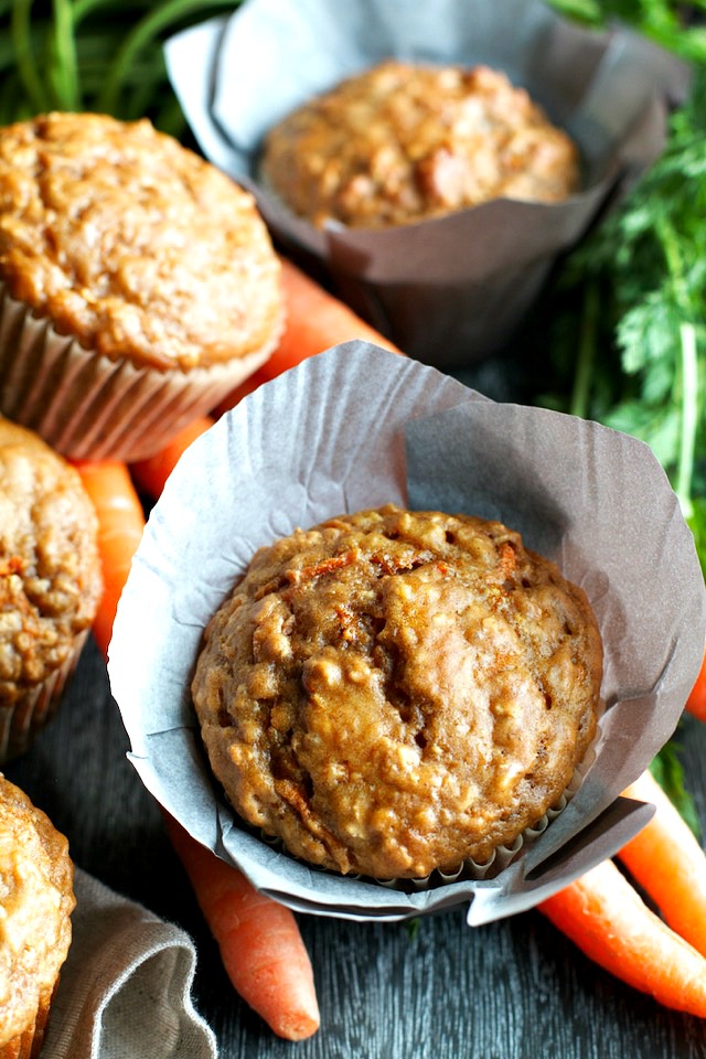 You won't find any butter or oil in these ridiculously soft and tender Carrot Oatmeal Greek Yogurt Muffins! What you will find is plenty of naturally sweetened, carrot-y goodness in each bite! | runningwithspoons.com #healthy #muffins #breakfast #snack