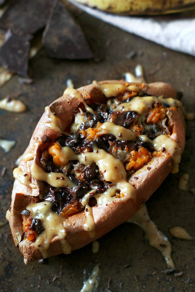 These Chunky Monkey Stuffed Sweet Potatoes are loaded with gooey caramelized bananas and melted dark chocolate before being topped with a creamy banana nut sauce. An irresistibly delicious gluten free and vegan treat! | runningwithspoons.com #recipe #healthy #sweetpotatoes #vegan