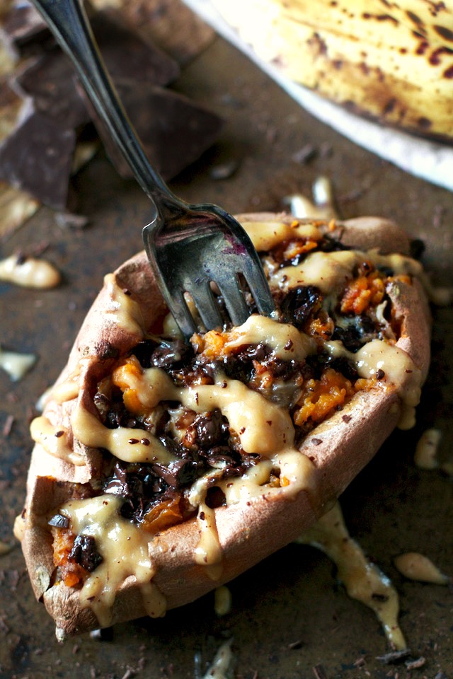 These Chunky Monkey Stuffed Sweet Potatoes are loaded with gooey caramelized bananas and melted dark chocolate before being topped with a creamy banana nut sauce. An irresistibly delicious gluten free and vegan treat! | runningwithspoons.com #recipe #healthy #sweetpotatoes #vegan