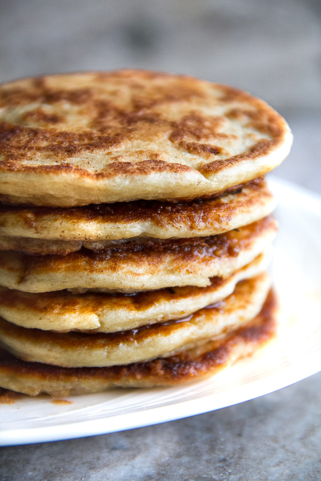 Cinnamon Roll Greek Yogurt Pancakes - these DELICIOUS light and fluffy pancakes taste just like a warm cinnamon roll and will keep you satisfied all morning with over 20g of whole food protein! | runningwithspoons.com #glutenfree #healthy #breakfast