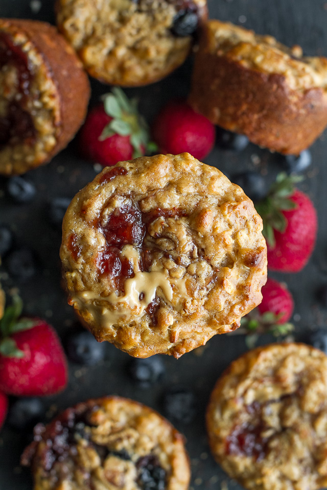 You won't find any butter or oil in these healthy Almond Butter & Jelly Muffins! The recipe calls for Greek yogurt to keep them soft and tender, with swirls of almond butter and jelly to add tonnes of flavour. | runningwithspoons.com