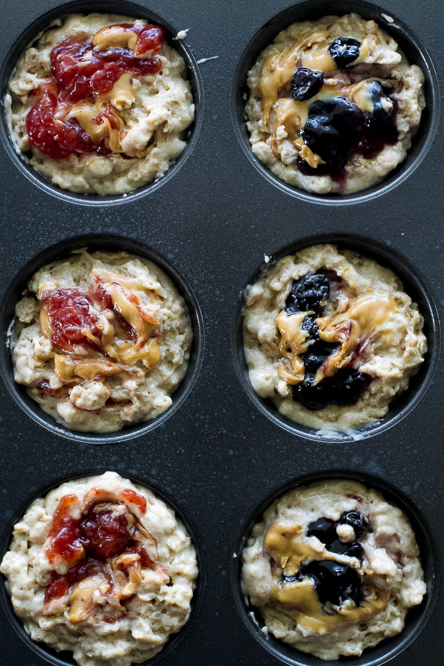 You won't find any butter or oil in these healthy Almond Butter & Jelly Muffins! The recipe calls for Greek yogurt to keep them soft and tender, with swirls of almond butter and jelly to add tonnes of flavour. | runningwithspoons.com