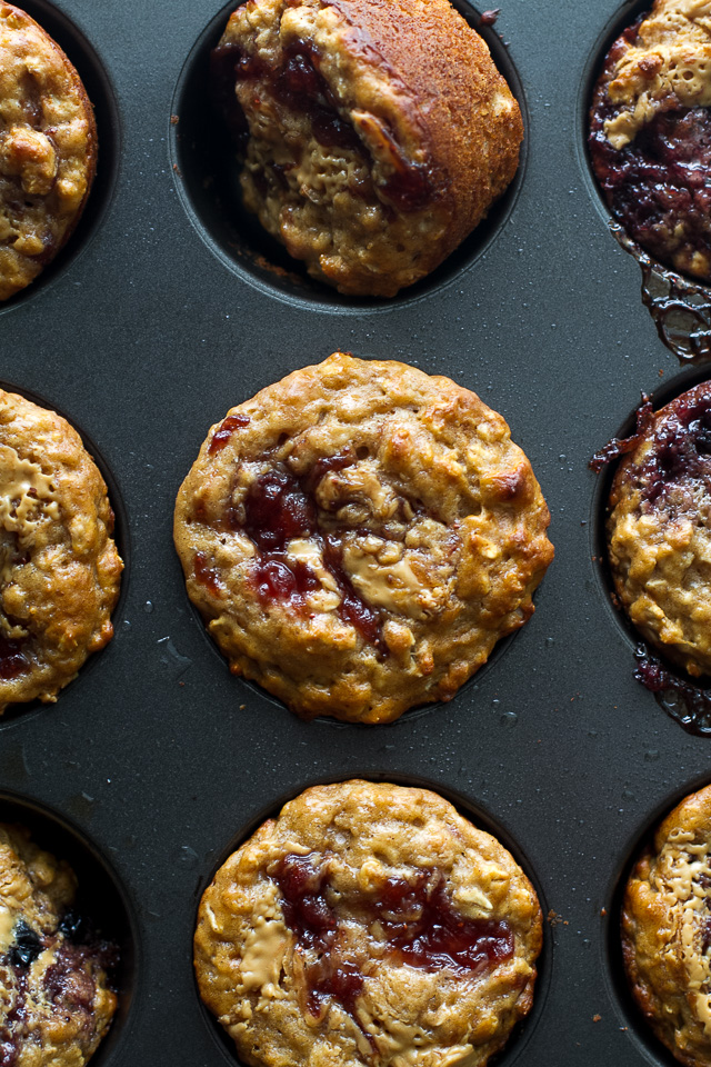 You won't find any butter or oil in these healthy Almond Butter & Jelly Muffins! The recipe calls for Greek yogurt to keep them soft and tender, with swirls of almond butter and jelly to add tonnes of flavour. | runningwithspoons.com