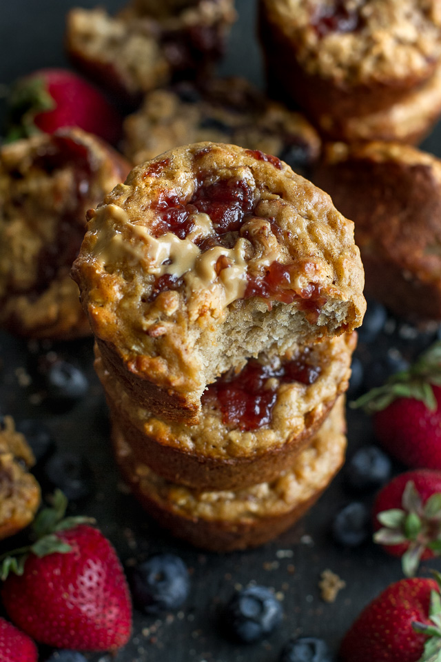 You won't find any butter or oil in these healthy Almond Butter & Jelly Muffins! The recipe calls for Greek yogurt to keep them soft and tender, with swirls of almond butter and jelly to add tonnes of flavour. | runningwithspoons.com