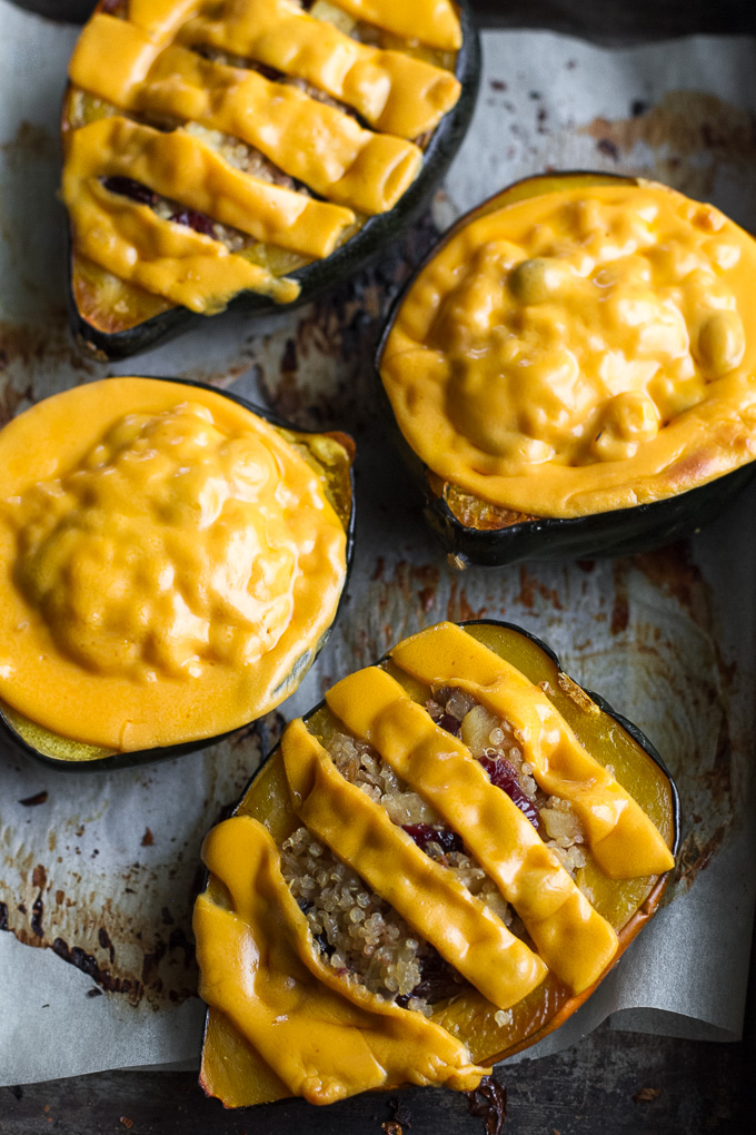 This cheezy apple cranberry quinoa stuffed squash is packed with sweet & savoury flavours and topped with an ooey, gooey, dairy-free cheese. It's healthy plant-based comfort food at its finest! | runningwithspoons.com