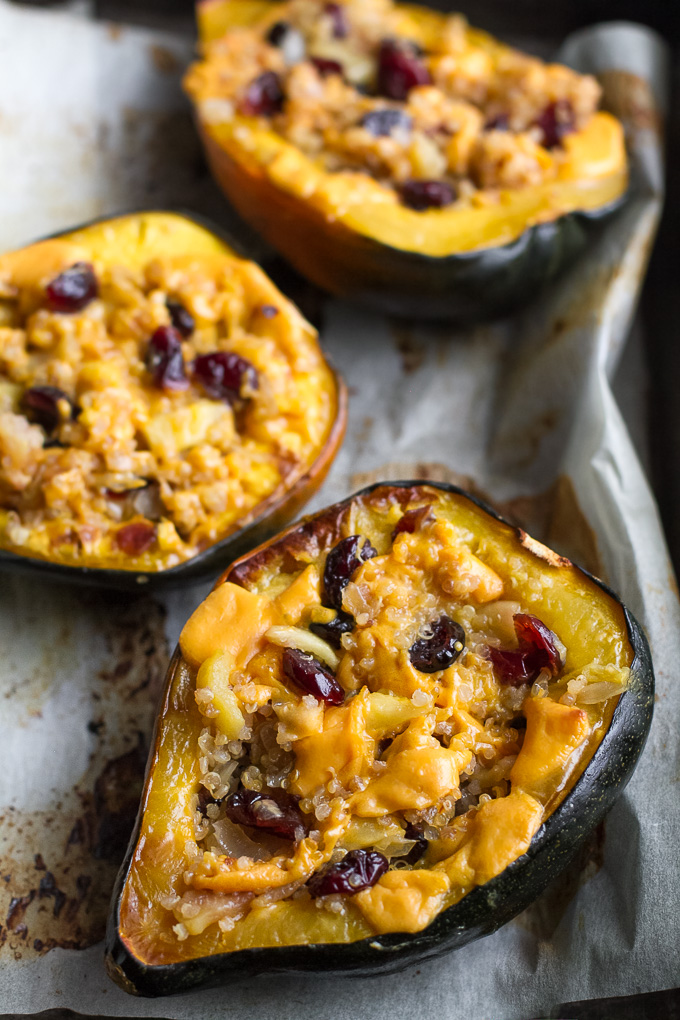 This cheezy apple cranberry quinoa stuffed squash is packed with sweet & savoury flavours and topped with an ooey, gooey, dairy-free cheese. It's healthy plant-based comfort food at its finest! | runningwithspoons.com