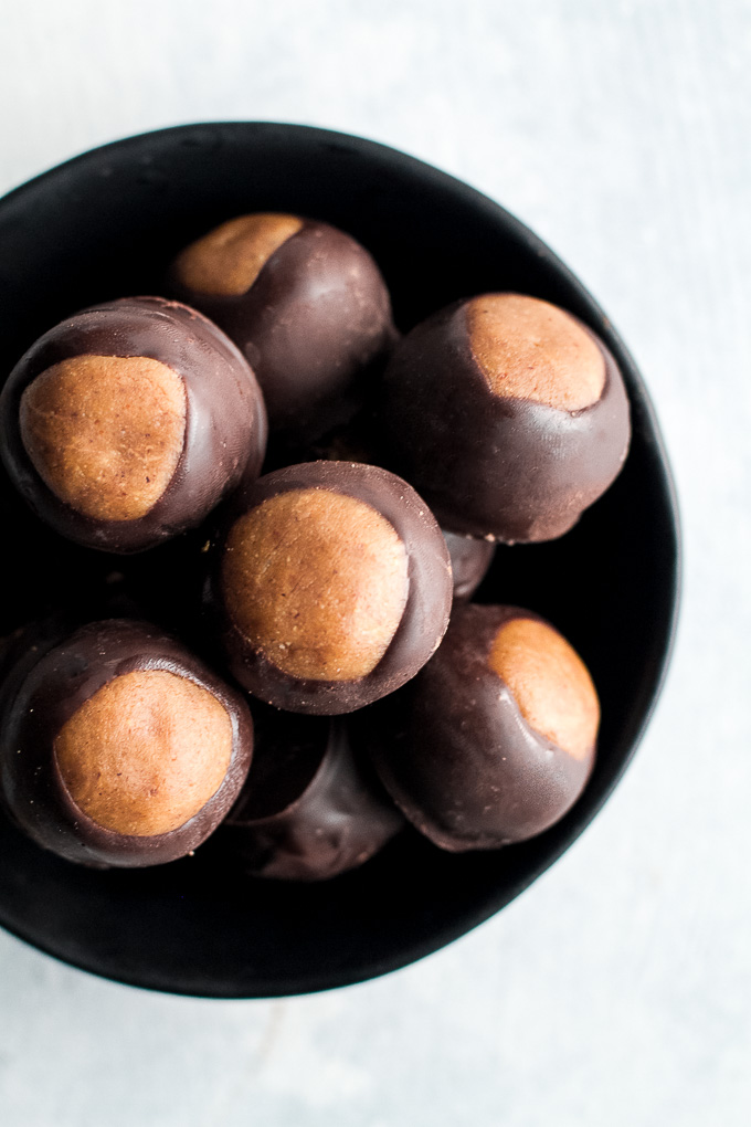 You won't miss the butter or sugar in these healthy buckeyes! They're made with wholesome ingredients like coconut flour and maple syrup, and make a delicious alternative to a traditional favourite! {gluten-free, vegan, paleo} | runningwithspoons.com