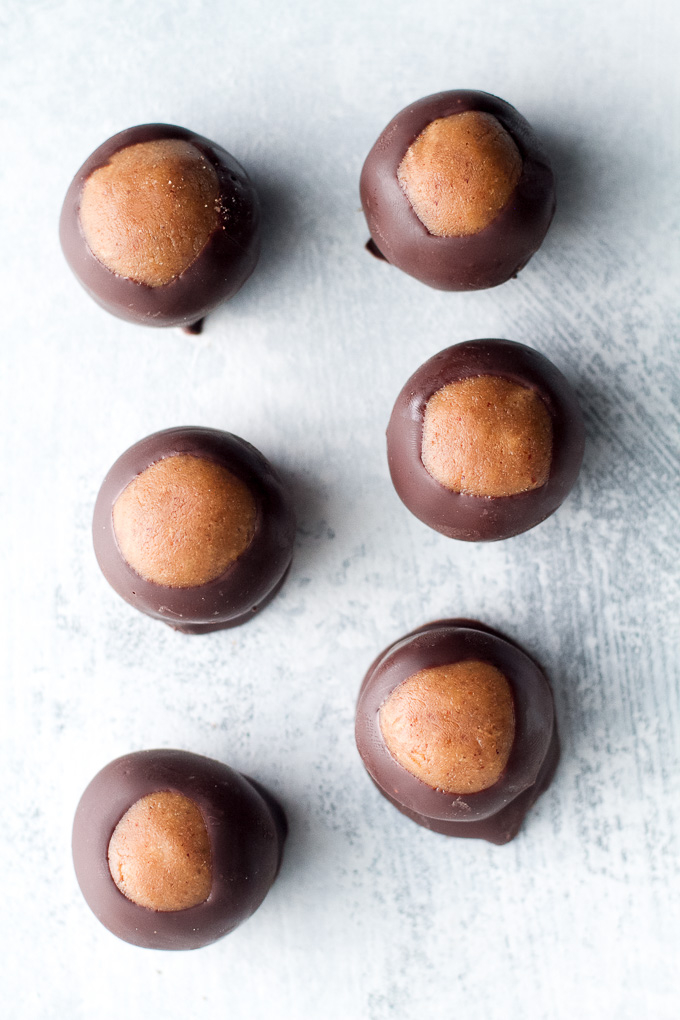 You won't miss the butter or sugar in these healthy buckeyes! They're made with wholesome ingredients like coconut flour and maple syrup, and make a delicious alternative to a traditional favourite! {gluten-free, vegan, paleo} | runningwithspoons.com