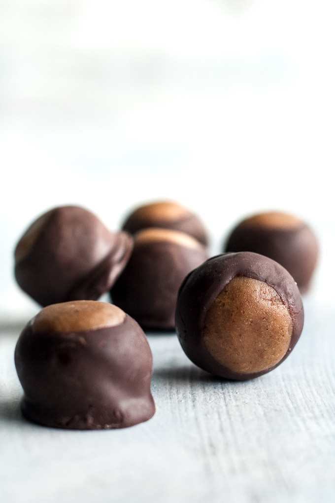 You won't miss the butter or sugar in these healthy buckeyes! They're made with wholesome ingredients like coconut flour and maple syrup, and make a delicious alternative to a traditional favourite! {gluten-free, vegan, paleo} | runningwithspoons.com