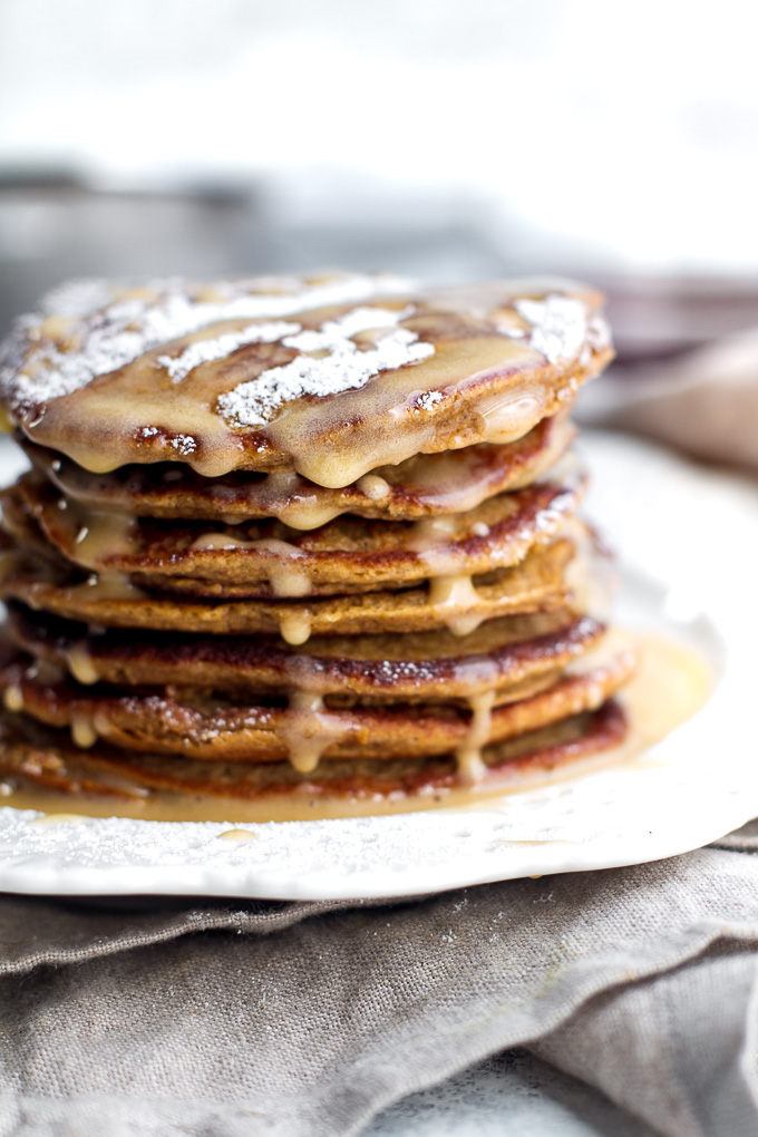 These light and fluffy Gingerbread Greek Yogurt Pancakes are sure to keep you satisfied all morning with over 20g of whole food protein! They’re gluten-free thanks to the oats, whipped up in the blender in under 5 minutes, and LOADED with sweetness and spice | runningwithspoons.com