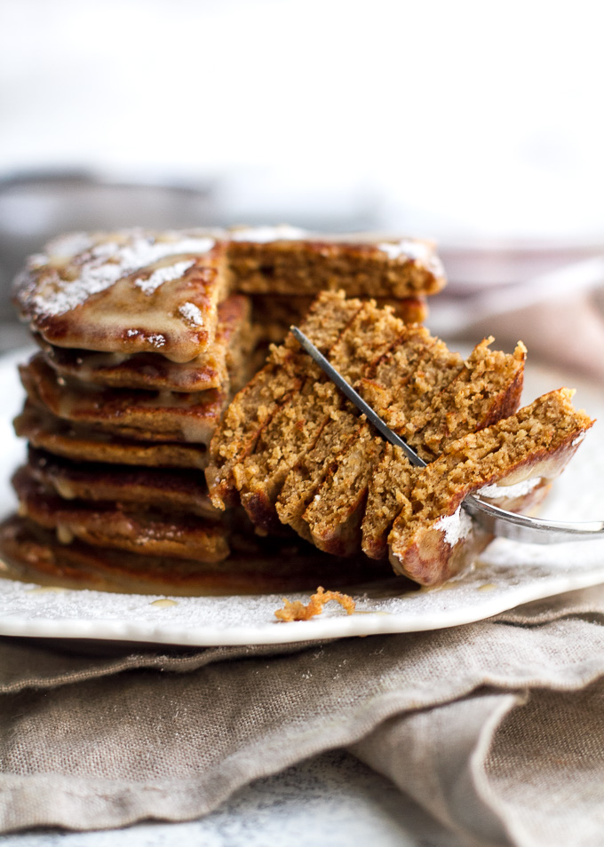 These light and fluffy Gingerbread Greek Yogurt Pancakes are sure to keep you satisfied all morning with over 20g of whole food protein! They’re gluten-free thanks to the oats, whipped up in the blender in under 5 minutes, and LOADED with sweetness and spice | runningwithspoons.com