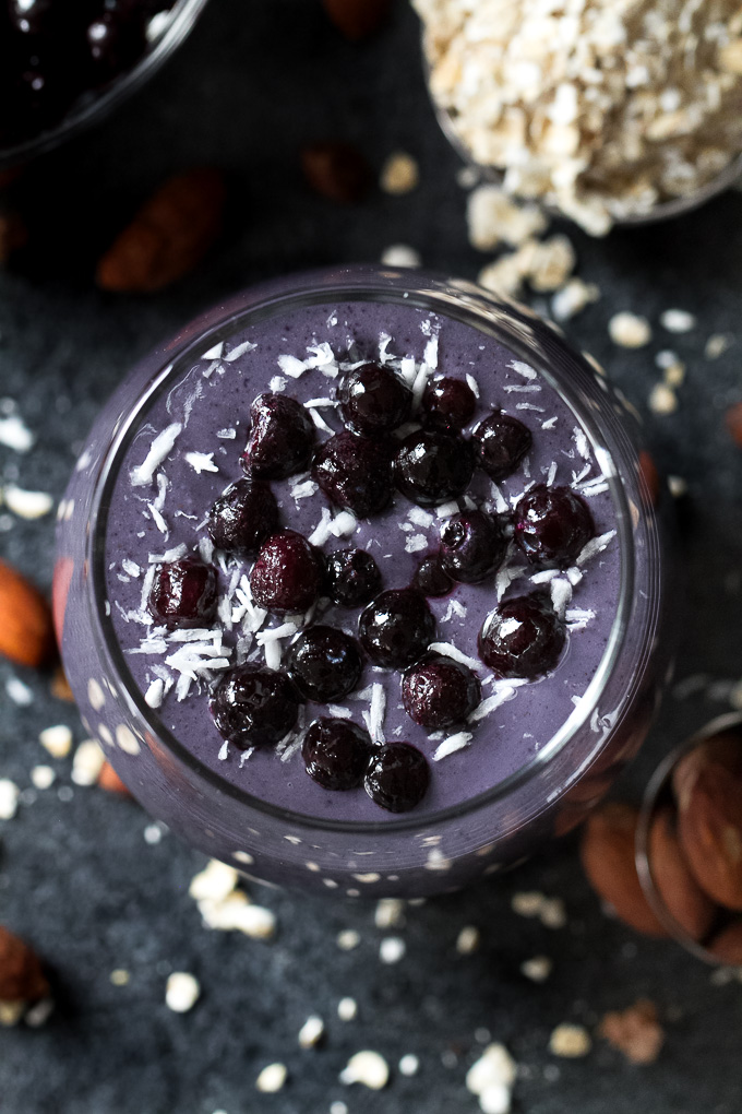 Cool, creamy, and ridiculously comforting! This Blueberry Muffin Breakfast Smoothie uses oats and almond butter to give it a subtle doughiness that pairs perfectly with the fresh and vibrant flavours blueberries and bananas. | runningwithspoons.com