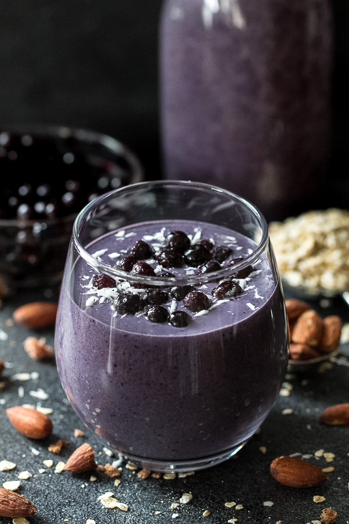 Cool, creamy, and ridiculously comforting! This Blueberry Muffin Breakfast Smoothie uses oats and almond butter to give it a subtle doughiness that pairs perfectly with the fresh and vibrant flavours blueberries and bananas. | runningwithspoons.com