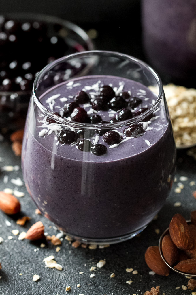 Cool, creamy, and ridiculously comforting! This Blueberry Muffin Breakfast Smoothie uses oats and almond butter to give it a subtle doughiness that pairs perfectly with the fresh and vibrant flavours blueberries and bananas. | runningwithspoons.com