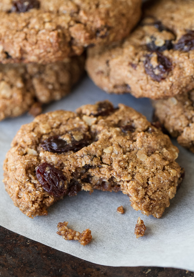 A soft and chewy flourless oatmeal raisin cookie with a bite taken out of it.