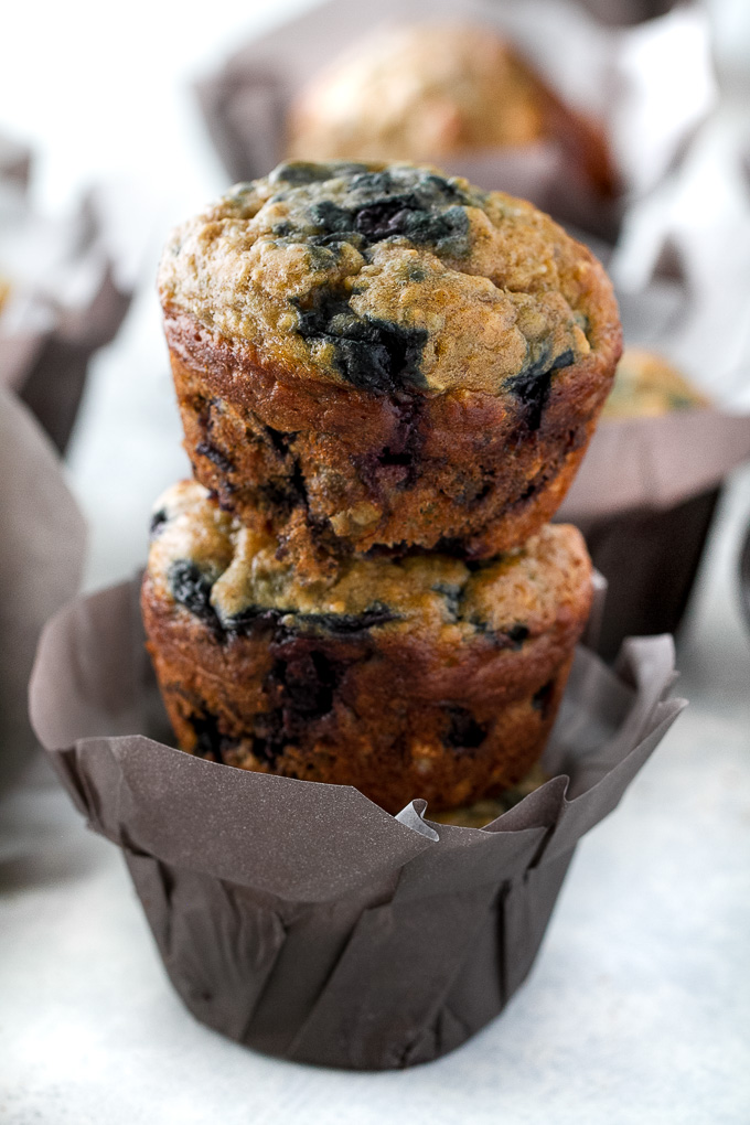 These blueberry banana oatmeal muffins are made with NO butter or oil, but so soft and tender that you'd never be able to tell! Super easy to whip up in only ONE BOWL, they make a deliciously healthy breakfast or snack. | runningwithspoons.com