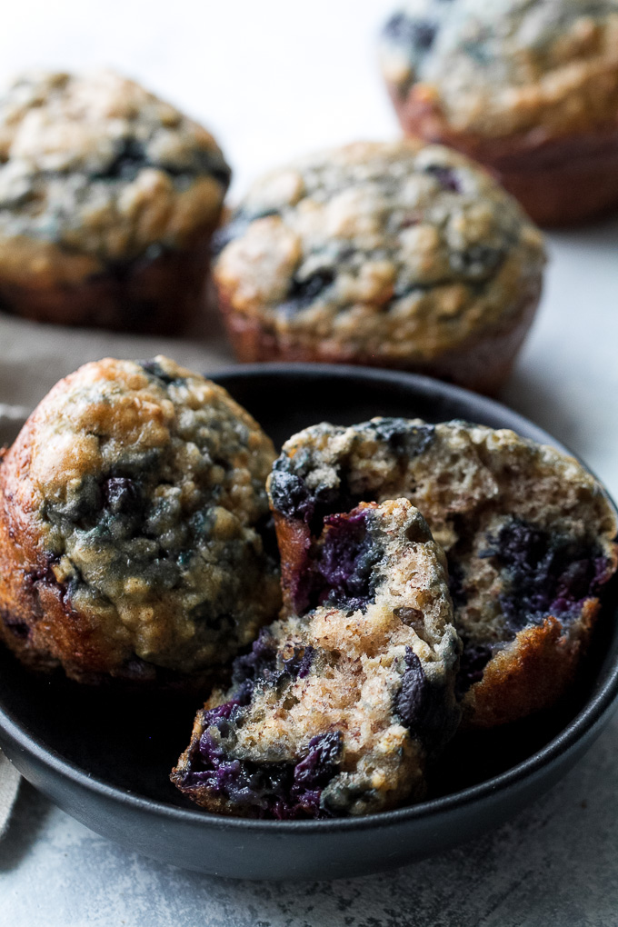 These blueberry banana oatmeal muffins are made with NO butter or oil, but so soft and tender that you'd never be able to tell! Super easy to whip up in only ONE BOWL, they make a deliciously healthy breakfast or snack. | runningwithspoons.com