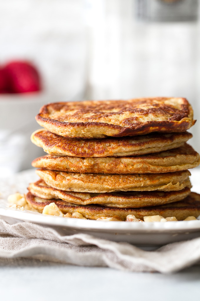 These light and fluffy Carrot Cake Greek Yogurt Pancakes are sure to keep you satisfied all morning with over 20g of whole food protein! They’re gluten-free thanks to the oats and whipped up in the blender in under 5 minutes! | runningwithspoons.com