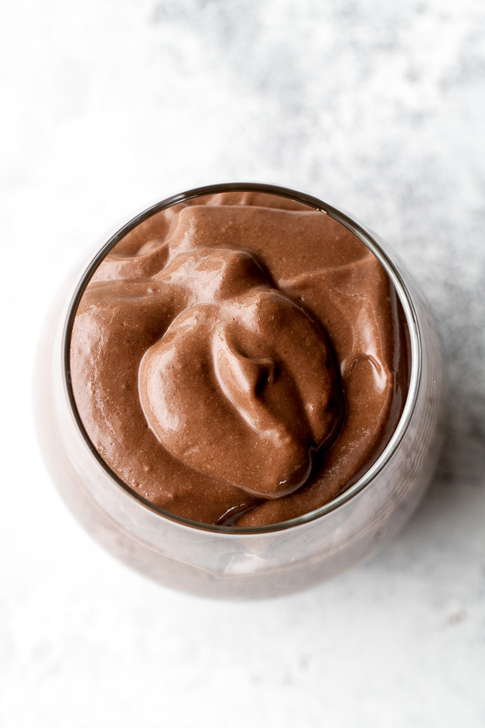 Healthy Chocolate Ice Cream Smoothie - It may sound decadent, but this smoothie is actually super healthy and made with good-for-you ingredients like cocoa, avocado, and banana. Luscious, creamy, and super satisfying, it makes a perfect choice for when those chocolate cravings hit {vegan, gluten-free, refined sugar-free} | runningwithspoons.com