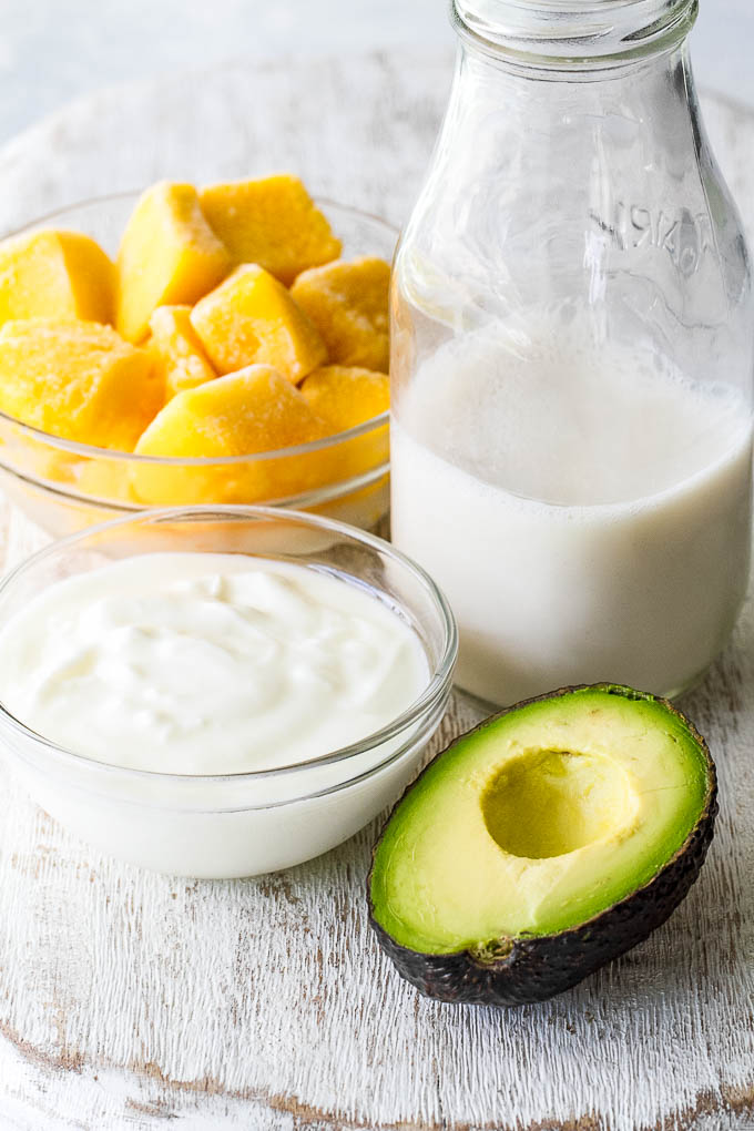 This super creamy Mango Avocado Smoothie is packed with protein, healthy fats, vitamins and antioxidants. Gluten-free and easily made vegan, it makes a healthy and delicious breakfast or snack | runningwithspoons.com