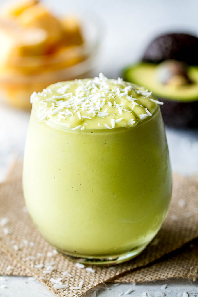 This super creamy Mango Avocado Smoothie is packed with protein, healthy fats, vitamins and antioxidants. Gluten-free and easily made vegan, it makes a healthy and delicious breakfast or snack | runningwithspoons.com