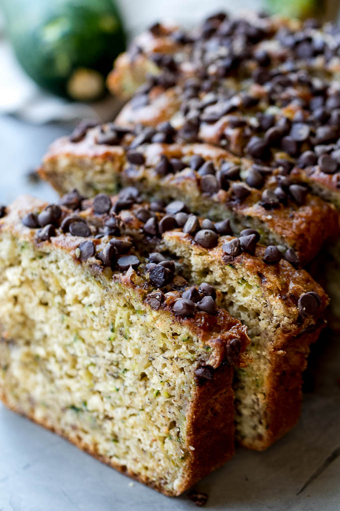 One Bowl Zucchini Banana Bread - made without butter or oil, but so tender and flavourful that you’d never be able to tell it's healthy! Greek yogurt, bananas, and shredded zucchini keep it extra moist, while a sprinkle of chocolate chips make it feel extra decadent | runningwithspoons.com