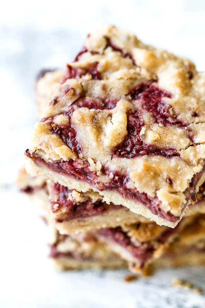 Strawberry Almond Oat Bars - so tender and buttery that you'd never guess they're made without any flour or butterl! A gluten-free combination of oats and almond flour gives them an irresistibly flaky crust, which pairs beautifully with an easy homemade strawberry chia seed jam | runningwithspoons.com