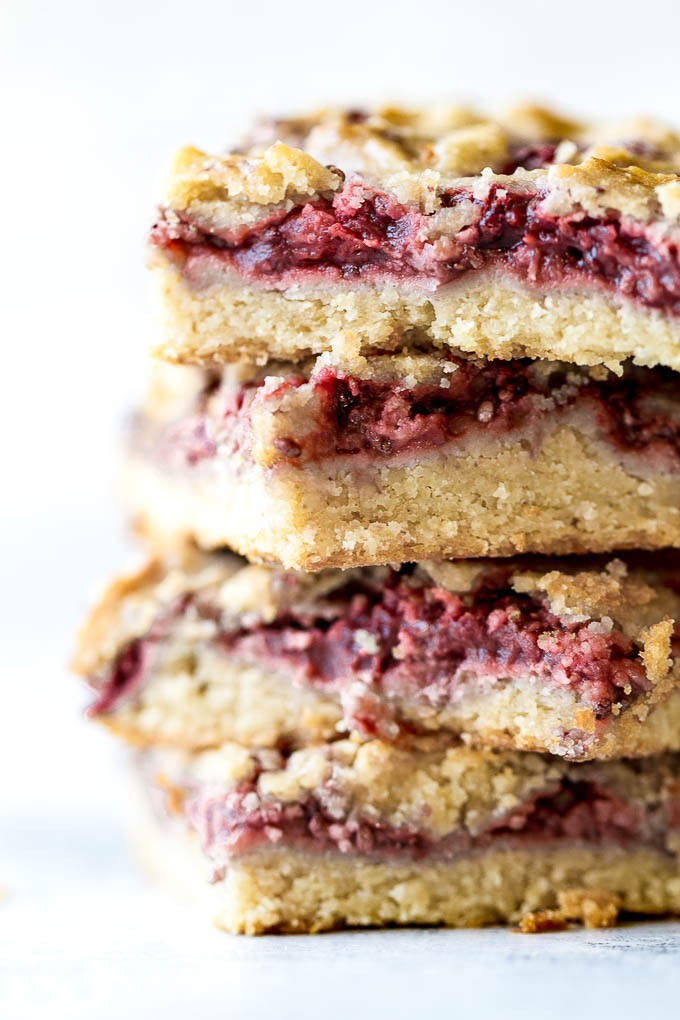 Strawberry Almond Oat Bars - so tender and buttery that you'd never guess they're made without any flour or butterl! A gluten-free combination of oats and almond flour gives them an irresistibly flaky crust, which pairs beautifully with an easy homemade strawberry chia seed jam | runningwithspoons.com