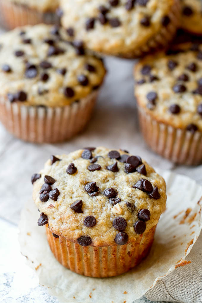 One Bowl Chocolate Chip Banana Oat Muffins - so soft and tender that you'd never guess they're made without butter or oil. Deliciously healthy and SUPER easy to whip up using just one bowl! | runningwithspoons.com