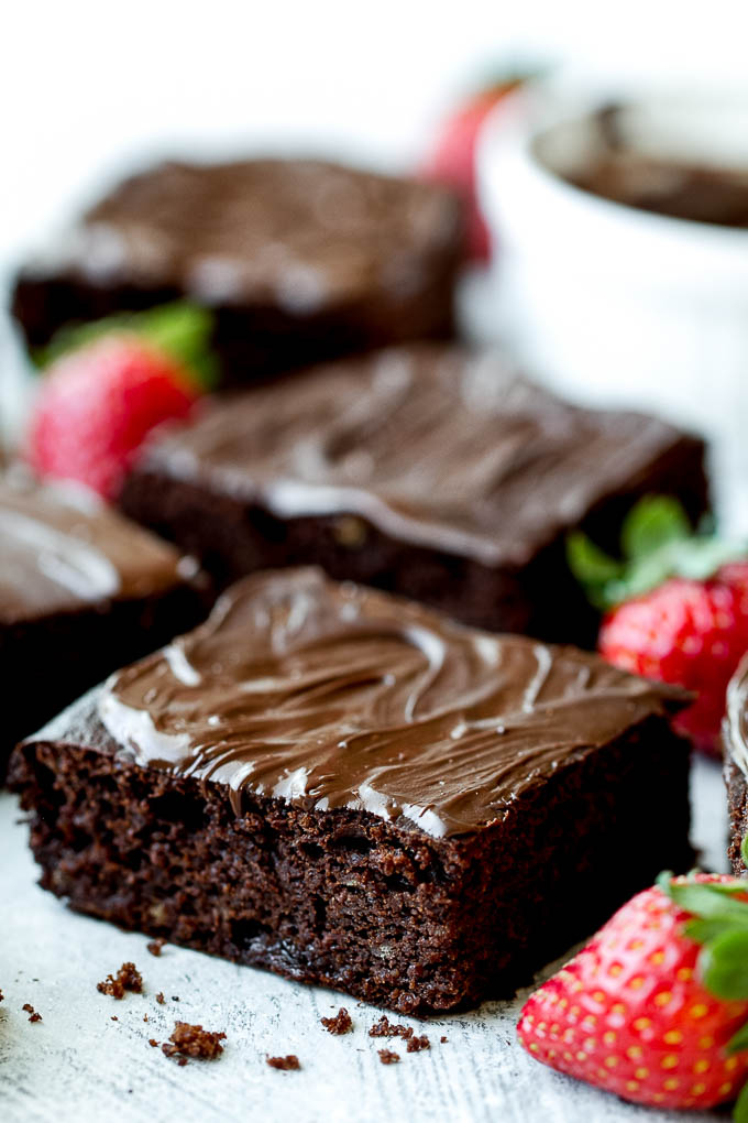 Flourless Strawberry Brownies made in one bowl with super simple ingredients! They’re grain-free, oil-free, and refined-sugar-free, so they make a deliciously healthy gluten-free and paleo treat for when those chocolate cravings hit | runningwithspoons.com