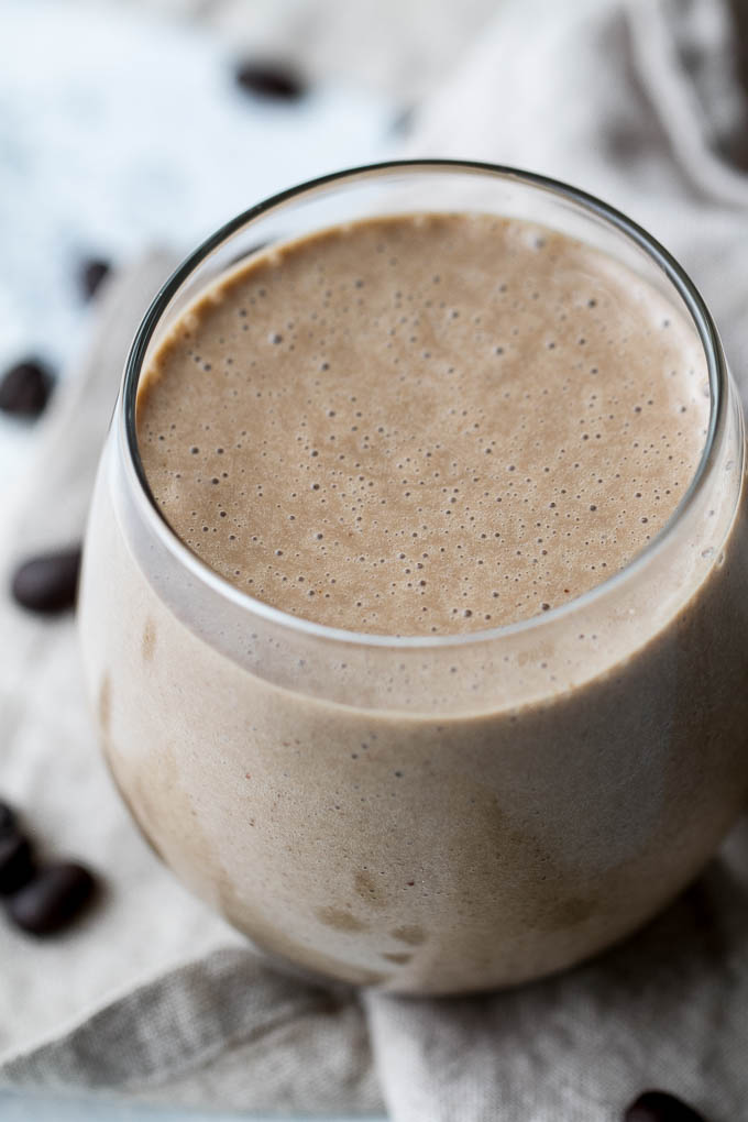 Coffee lovers rejoice! This creamy Banana Latte Overnight Oatmeal Smoothie combines that stick-to-your-ribs feeling of a bowl of oats with the silky smooth texture of a smoothie... plus your morning cup of coffee!! Vegan, gluten-free, and packed with plant-based protein and fiber, it makes a healthy and easy breakfast or afternoon snack! | runningwithspoons.com #recipe #coffee #smoothie #vegan