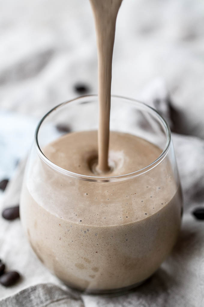 Coffee lovers rejoice! This creamy Banana Latte Overnight Oatmeal Smoothie combines that stick-to-your-ribs feeling of a bowl of oats with the silky smooth texture of a smoothie... plus your morning cup of coffee!! Vegan, gluten-free, and packed with plant-based protein and fiber, it makes a healthy and easy breakfast or afternoon snack! | runningwithspoons.com #recipe #coffee #smoothie #vegan